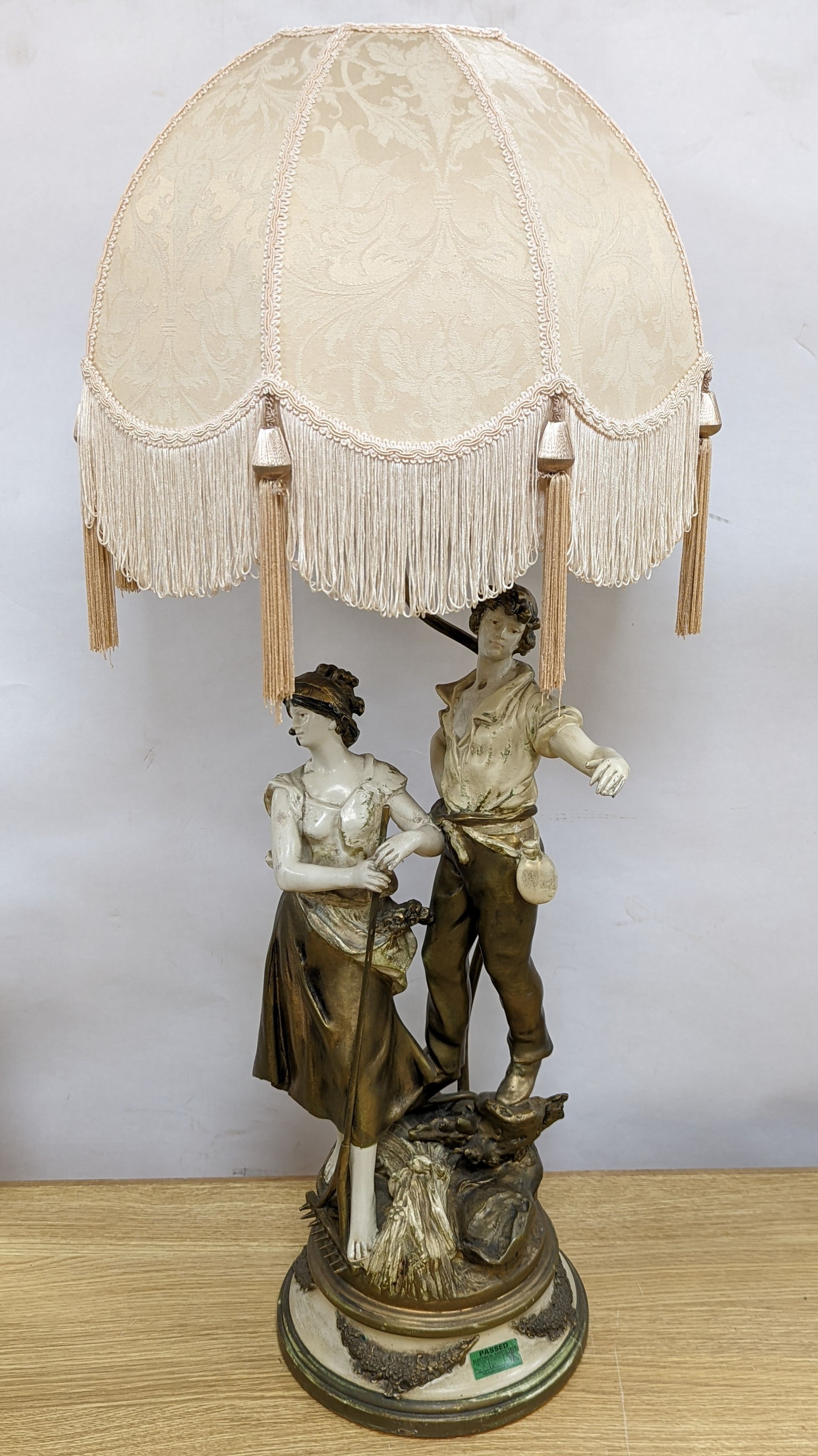 After L & F Moreau - a painted spelter figural table lamp, peasant girl and boy, 96 cms high including shade.